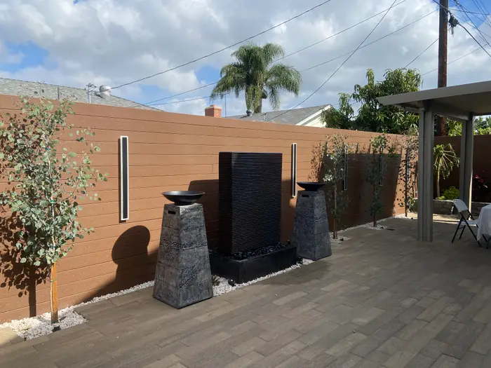 Patio cover beside a water wall and paver patio, Buena Park